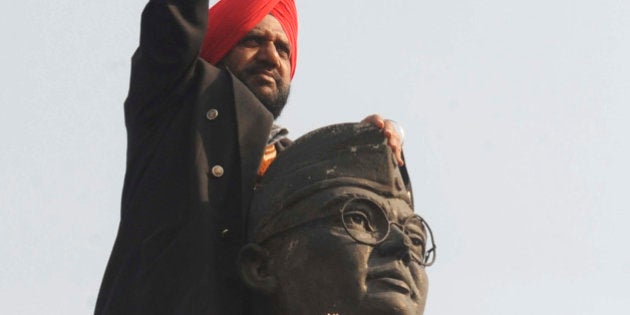 Member of the All India Azad Hind Fauj Freedom-Fighters Successors Association ,Tarsem Singh, gestures on the statue of freedom fighter, Subash Chandra Bose, in Amritsar, on January 23, 2011, as part of celebrations for his 114th birth anniversary. Bose known as Netaji, was the leader of the movement to free India from Birtish rule and commanded the Indian National Army during World War II. AFP PHOTO/NARINDER NANU (Photo credit should read NARINDER NANU/AFP/Getty Images)