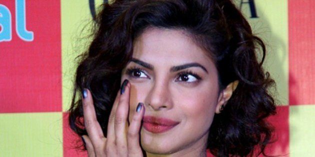 Indian Bollywood film actress Priyanka Chopra poses during the launch of the latest Grazia magazine cover in Mumbai on December 17, 2014. AFP PHOTO (Photo credit should read STR/AFP/Getty Images)
