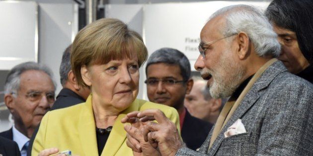 German Chancellor Angela Merkel (L) and Indian Prime Minister Narendra Modi (R) inspect some bionicANTs produced by FESTO at the Hannover Messe industrial trade fair in Hanover, central Germany on April 13, 2015. India is the partner country of this year's trade fair running until April 17, 2015. AFP PHOTO / TOBIAS SCHWARZ (Photo credit should read TOBIAS SCHWARZ/AFP/Getty Images)