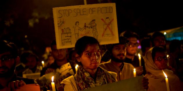 AP10ThingsToSee - Acid attack survivors participate in a candlelit vigil protesting violence against women as they mark the second anniversary of the deadly gang rape of a student on a bus, in New Delhi, India, Tuesday, Dec. 16, 2014. The case sparked public outrage and helped make womenâs safety a common topic of conversation in a country where rape is often viewed as a womanâs personal shame to bear. (AP Photo/Saurabh Das)