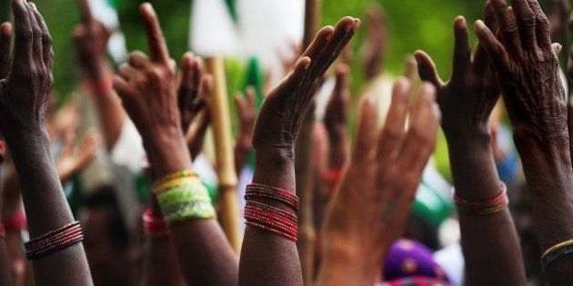 Indian farmers of the Bharatiya Kisan Union (BKU) - Indian Farmers' Union - raise their hands as they listen to spoeeches during a protest demanding compensation for damage to crops due to fluctuating rains and the waiving of electricity bills and loan interest, in Allahabad on April 7, 2015. AFP PHOTO / SANJAY KANOJIA (Photo credit should read Sanjay Kanojia/AFP/Getty Images)