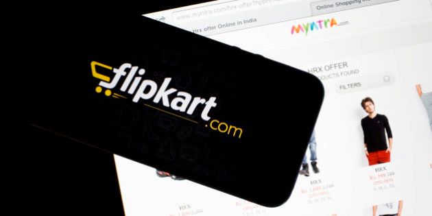 Flipkart's application loading page, left, and the Myntra.com website are displayed on an Apple Inc. iPhone 5c and iPad respectively an arranged photograph in Hong Kong, China, on Wednesday, May 21, 2014. Flipkart, India's largest online retailer, will buy competitor Myntra.com, according to people with knowledge of the talks, to gain a business with higher margins and strengthen its position in the local market against Amazon.com Inc. Photographer: Brent Lewin/Bloomberg via Getty Images