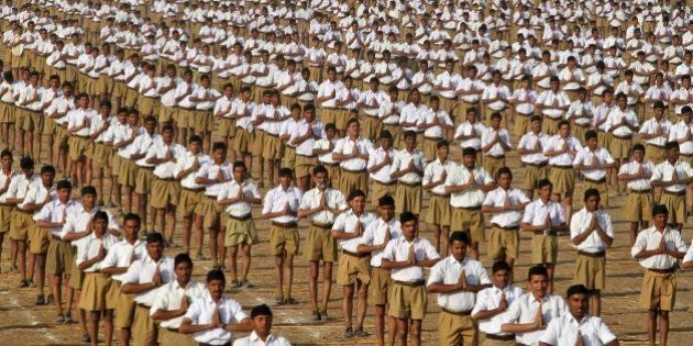 Volunteers of the militant Hindu group Rashtriya Swayamsevak Sangh (RSS) perform Surya Namaskar or sun salutation during the concluding ceremony of its three day long karyakarta shibir, or workersâ conclave on the outskirts of Ahmadabad, India, Sunday, Jan. 4, 2015. The RSS, parent organization of the ruling Bharatiya Janata Party, combines religious education with self-defense exercises. The organization has long been accused of stoking religious hatred against Muslims. (AP Photo/Ajit Solanki)