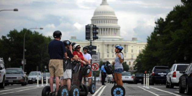 A Segway tour group stops on the new Pennsylvania Avenue bicycle lanes near the US Capitol for some narration from their guide on August 2, 2010 in Washington. AFP PHOTO/Tim Sloan (Photo credit should read TIM SLOAN/AFP/Getty Images)