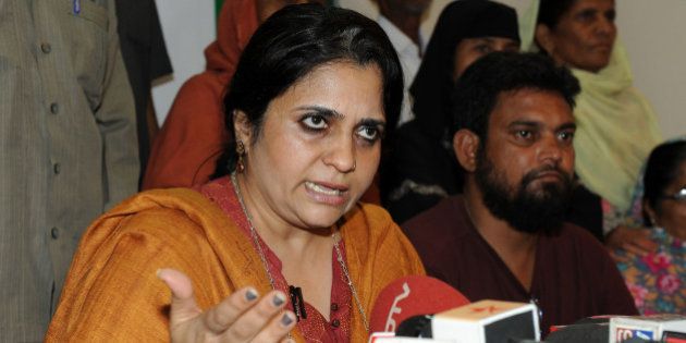 Teesta Setalvad (C), Secretary of Citizens for Justice and Peace, speaks to the media during a press conference in Ahmedabad on March 22, 2010. Teesta said that Gujarat state Chief Minister Narendra Modi should appear before the Special Investigation Team constituted by the Supreme Court of India. Congress Member of Parliament (MP) Ehsan Jafri was amongst a total of 59 Muslims hacked to death on February 28, 2002 by a rioting mob in Ahmedabad's Gulberg Society. Zakia Ehsan Jafri widow of slained Congress MP Ehsan Jafri filed a case against 62 people including Gujarat state Chief Minister Narendra Modi in the Indian Supreme Court which prompted the Special Investigation Team (SIT) to summon Narendra Modi. AFP PHOTO/ Sam PANTHAKY (Photo credit should read SAM PANTHAKY/AFP/Getty Images)