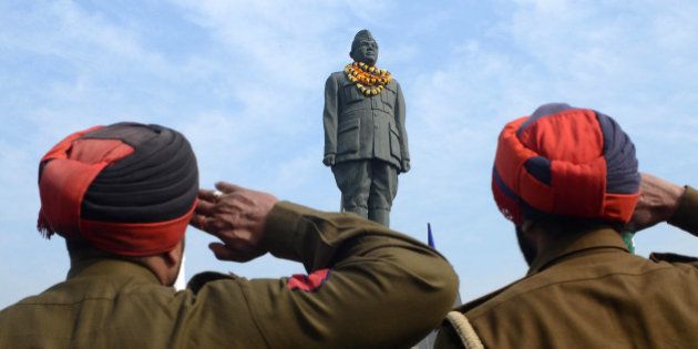 Indian Punjab police salute the statue of freedom fighter, Netaji Subhash Chandra Bose in Amritsar on January 23, 2013, as part of celebrations for his 116th birth anniversary. Bose was a prominent Indian nationalist leader who attempted to gain India's independence from British rule by force during the waning years of World War II. AFP PHOTO/NARINDER NANU (Photo credit should read NARINDER NANU/AFP/Getty Images)