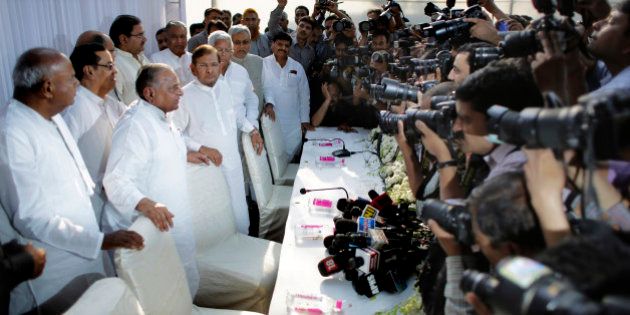 Indian photographers take pictures of Janata Dal (Secular) party leader H.D. Deve Gowda, left, Samajwadi Party chief Mulayam Singh Yadav, second left, Janata Dal (United), a powerful group in eastern Bihar state, chief Sharad Yadav, center, Bihar state chief minister Nitish Kumar, second right, and former Indian Railway Minister and leader of Rashtriya Janata Dal Lalu Prasad Yadav, during a press conference in New Delhi, India, Wednesday, April 15, 2015. Six parties that were once part of âJanata Parivarâ, a term used in Indian politics to describe the various political parties that emerged from Janata Dal party, announced on Wednesday that they will merge to form a national party under the leadership of Mulayam Singh Yadav. (AP Photo/Altaf Qadri)