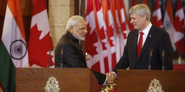 Canada's Prime Minister Stephen Harper shakes hands with India's Prime Minister Narendra Modi (L) during a joint press conference on Parliament Hill in Ottawa, Canada on April 15, 2015. Prime Minister Modi will continue his official visit to Canada in Toronto and Vancouver. AFP PHOTO/ COLE BURSTON (Photo credit should read Cole Burston/AFP/Getty Images)