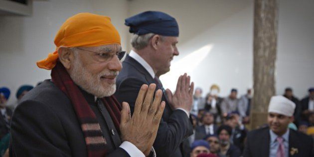 India's Prime Minister Narendra Modi (L) and Canada's Prime Minister Stephen Harper (R) walk together during a visit to the Gurdwara Khalsa Diwan in Vancouver, British Columbia, April 16, 2015. Modi is on an official visit to Canada. AFP PHOTO / Pool / ANY CLARK (Photo credit should read ANDY CLARK/AFP/Getty Images)