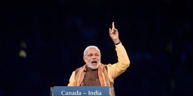 Indian Prime Minister Narendra Modi addresses a crowd of nearly 10,000 during a rally at Ricoh Coliseum in Toronto on Prime Minister Modi's first official visit to Canada, April 15, 2015. Nearly 1.2 million Canadians trace their roots to India. South Asians are the largest visible minority in Canada. AFP PHOTO / GEOFF ROBINS (Photo credit should read GEOFF ROBINS/AFP/Getty Images)