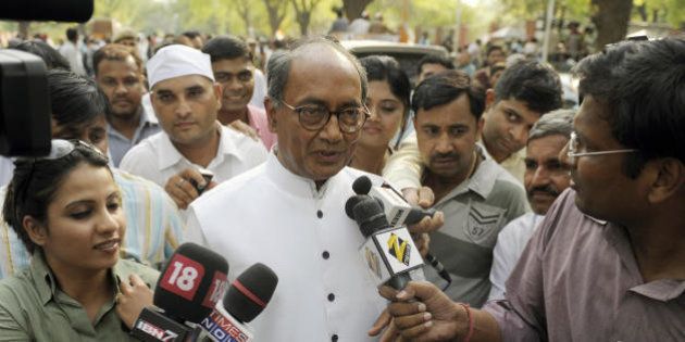Congress Party General Secretary Digvijay Singh is surrounded by journalists as he exits Congress Party President Sonia Gandhi's residence in New Delhi on May 16, 2009, during the vote counting process. India's ruling Congress-led alliance swept to a commanding election victory on May 16, crushing its Hindu nationalist rivals and setting up a second term for Prime Minister Manmohan Singh. With results still coming in from the Election Commission, the Congress grouping was on track to win around 250 seats against 160 for the main opposition bloc headed by the Bharatiya Janata Party (BJP). AFP PHOTO/ Manpreet ROMANA (Photo credit should read MANPREET ROMANA/AFP/Getty Images)