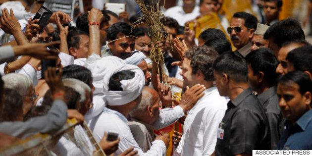 Congress party Vice President Rahul Gandhi interacts with farmers outside his residence in New Delhi, India, Saturday, April 18, 2015. Gandhi will lead a farmersâ rally on Sunday against the ruling Bharatiya Janata Partyâs Land Acquisition Bill, calling it anti-farmer in a country where agriculture is the main livelihood for more than 60 percent of the 1.2 billion people. (AP Photo/Altaf Qadri)