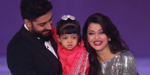 Former Miss World Aishwarya Rai, right speaks on stage with husband Abhishek Bachchan and daughter Aaradha, during the Miss World 2014 final, on stage at the Excel centre in east London, Sunday, Dec. 14, 2014. (Photo by Joel Ryan/Invision/AP)