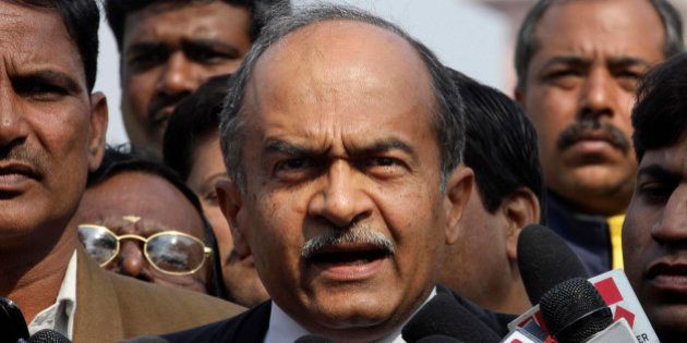 Indian lawyer and social activist Prashant Bhushan talks to the media outside the Supreme Court, in New Delhi, India, Thursday, Feb. 2, 2012. India's top court ordered the government on Thursday to cancel 122 cellphone licenses granted to companies during an irregular sale of spectrum that has been branded one of the largest scandals in India's history. (AP Photo)