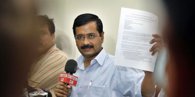 NEW DELHI, INDIA - OCTOBER 27: AAP Chief Arvind Kejriwal showing press release during the press conference on affidavit by government in Supreme Court on black money on October 27, 2014 in New Delhi, India. In its affidavit to the Supreme Court, the Indian government revealed the names of three individuals allegedly having Swiss bank account. Arvind Kejriwal accused government of selectively disclosing the names to protect some influential people. (Photo by Raj K Raj/Hindustan Times via Getty Images)