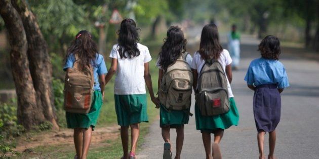Indian girls walk to a school at Burha Mayong village about 45 kilometers (28 miles) east of Gauhati, India, Thursday, April 9, 2015. According to the UNESCO Education for All Global Monitoring Report 2015, only half of all countries have achieved the most watched goal of universal primary enrollment. The report launched Thursday says, India has reduced its out of school children by over 90% Since 2000. (AP Photo/ Anupam Nath)