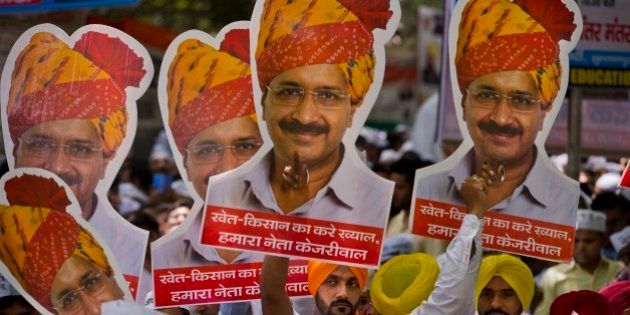 Indian farmers and Aam Aadmi Party or Common manâs party supporters display pictures of Delhi Chief Minister leader Arvind Kejriwal at a rally near the Indian parliament in New Delhi, India, Wednesday, April 22, 2015. Indian farmers and the opposition parties are protesting against a government plan to ease rules for obtaining land for industry and development projects. (AP Photo/Saurabh Das)