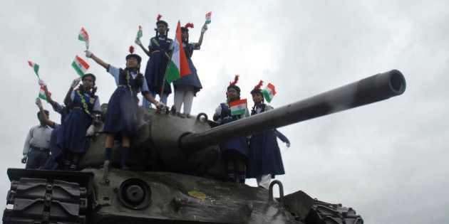 School children wave Indian national flag on top of an Indian army tank to celebrate Kargil Victory Day in Hyderabad, India, Saturday, July 26, 2008. This day marks the anniversary of 1999 India-Pakistan Kargil war. (AP Photo/Mahesh Kumar A)