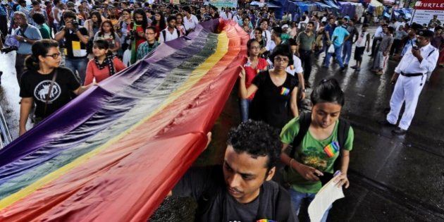 Lesbian, Gay, Bisexual and Transgender (LGBT) activists hold a rainbow flag as they participate in the Rainbow Pride Rally in Kolkata, India, Sunday, July 13, 2014. (AP Photo/Bikas Das)