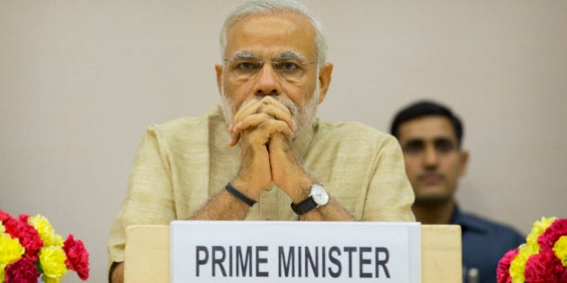 Indian Prime Minister Narendra Modi attends a function to mark the national Panchayati Raj or village civil council day, in New Delhi, India, Friday, April 24, 2015. Modi on Friday urged Panchayat members to work with a five-year vision with concrete development plans to bring about positive changes in their village and also emphasized on the need for education, according to local reports. (AP Photo/Manish Swarup)