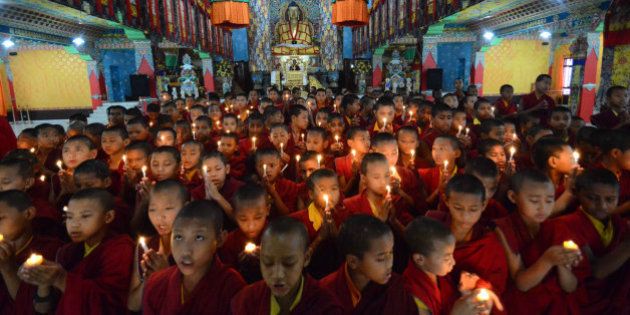 Novice Buddhist monks light candles and offer prayers for victims of Nepal's earthquake, in Bodhgaya, India, Sunday, April 26, 2015. Saturdayâs earthquake centered outside Kathmandu, the capital of Nepal, was the worst to hit the South Asian nation in over 80 years. It destroyed swaths of the oldest neighborhoods of Kathmandu, and was strong enough to be felt all across parts of India, Bangladesh, China's region of Tibet and Pakistan. (AP Photo/Manish Bhandari)