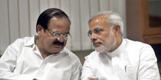 Bharatiya Janata Party (BJP) senior BJP leader M. Venkaiah Naidu (L) talks with Gujarat Chief Minister and BJP leader Narendra Modi at a meeting at BJP leader Lal Krishna Advani's residence in New Delhi on May 18, 2009. Advani had expressed his desire not to continue as Leader of Opposition in the new parliament after the BJP suffered a severe drubbing in the elections. India's ruling Congress-led alliance swept to a commanding election victory on May 16, crushing its Hindu nationalist rivals and setting up a second term for Prime Minister Manmohan Singh. AFP PHOTO/RAVEENDRAN (Photo credit should read RAVEENDRAN/AFP/Getty Images)