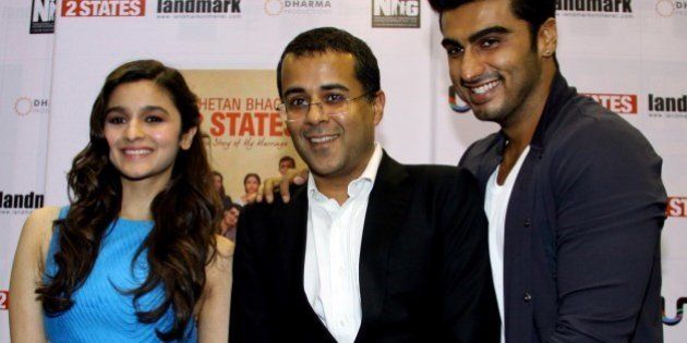 Indian author Chetan Bhagat (C) poses with Indian Bollywood actors Alia Bhatt (L) and Arjun Kapoor (R) during the launch of Bhagat's new book '2 States' in Mumbai on April 7, 2014. AFP PHOTO/STR (Photo credit should read STRDEL/AFP/Getty Images)