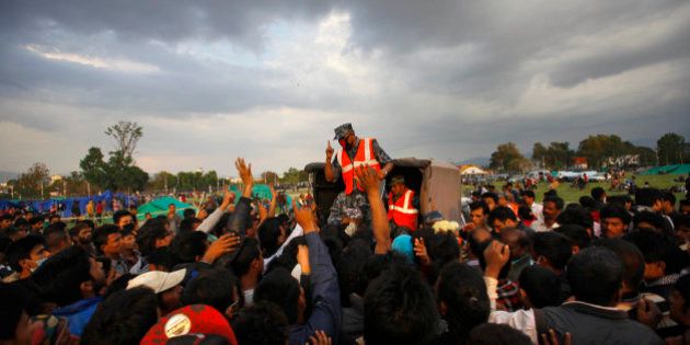 A Nepalese policeman requests earthquake victims to stand in a queue to receive tents in Kathmandu, Nepal, Sunday, April 26, 2015. The earthquake centered outside Kathmandu, the capital, was the worst to hit the South Asian nation in over 80 years. It destroyed swaths of the oldest neighborhoods of Kathmandu, and was strong enough to be felt all across parts of India, Bangladesh, China's region of Tibet and Pakistan. (AP Photo /Niranjan Shrestha)