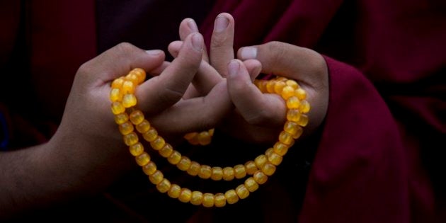 A Buddhist monk from Kopan monastery offers a prayer for the people affected during Saturday's earthquake in Kathmandu, Nepal, Monday, April 27, 2015. The earthquake was the worst to hit the South Asian nation in more than 80 years. It and was strong enough to be felt all across parts of India, Bangladesh, China's region of Tibet and Pakistan.(AP Photo/Bernat Armangue)