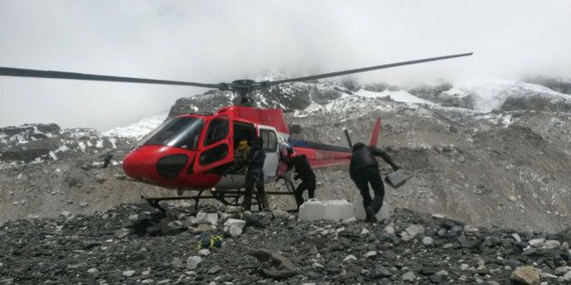 A rescue chopper lands carrying people from higher camps to Everest Base Camp, Nepal, Monday, April 27, 2015. An avalanche on Saturday, set off by the massive earthquake that struck Nepal, left more than a dozen people dead and dozens more injured. (AP Photo/Nima Namgyal Sherpa)