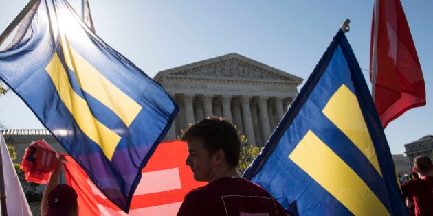 IMAGE DISTRIBUTED FOR HUMAN RIGHTS CAMPAIGN - Supporters of marriage equality gather outside the Supreme Court to demonstrate support for LGBT couples on Tuesday, April 28, 2015 in Washington. (Kevin Wolf/AP Images for Human Rights Campaign)