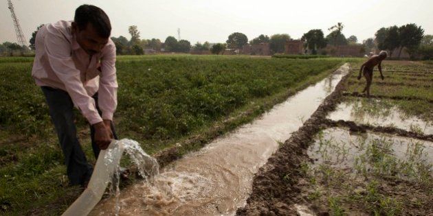 Indian farmer Jagdish Patel irrigates his field on the outskirts of Allahabad, India, Thursday, April 23, 2015.Almost three quarters of Indians still live in villages, and farm income is crucial to the country's economy. Unseasonal rain and hailstorms in March destroyed large areas of farmland in northern and western India, leading dozens of debt-ridden farmers to kill themselves.(AP Photo/Rajesh Kumar Singh)
