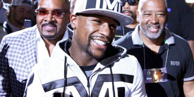 Boxer Floyd Mayweather Jr. walks to the stage during an arrival ceremony Tuesday, April 28, 2015, in Las Vegas. Mayweather will face Manny Pacquiao in a welterweight boxing match in Las Vegas on May 2. (AP Photo/John Locher)