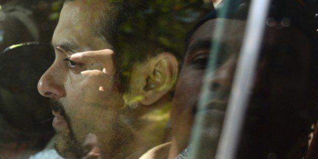 Indian Bollywood film actor Salman Khan leaves in a car after appearing at the sessions court in Mumbai on May 6, 2014. Khan appeared before the Mumbai court in connection with a hit-and-run case dating back to 2002. AFP PHOTO/ PUNIT PARANJPE (Photo credit should read PUNIT PARANJPE/AFP/Getty Images)
