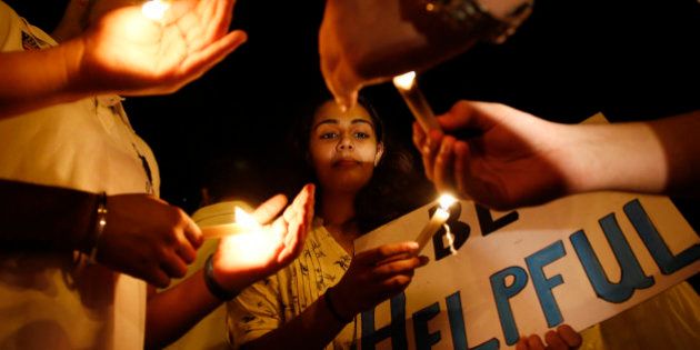 A college student participates in a candle light vigil for victims of Nepal's earthquake, in Mumbai, India, Wednesday, April 29, 2015. The 7.8 magnitude earthquake shook Nepalâs capital and the densely populated Kathmandu valley on Saturday devastating the region and leaving tens of thousands shell-shocked and sleeping in streets. (AP Photo/Rajanish Kakade)