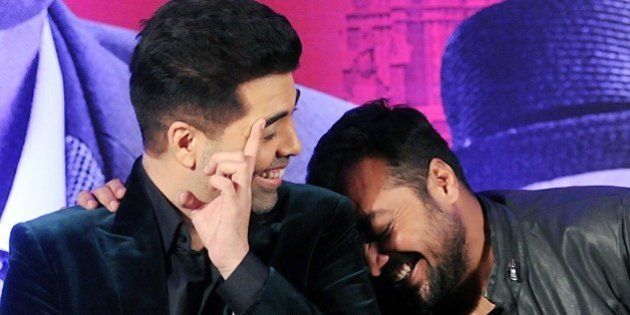 Indian Bollywood actor Karan Johar (L) and writer, director and producer Anurag Kashyap share a light moment during a promotional event for the forthcoming Hindi film 'Bombay Velvet' in Mumbai on late April 27, 2015. AFP PHOTO / STR (Photo credit should read STRDEL/AFP/Getty Images)