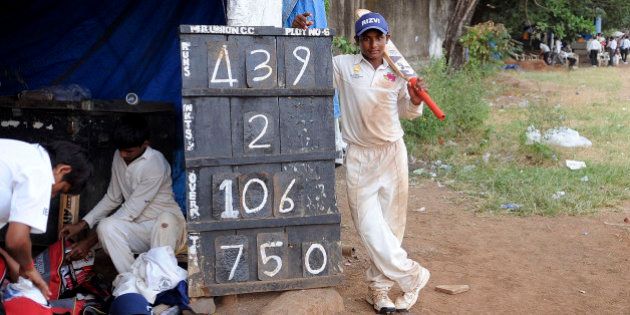 Sarfaraz Khan, 12, from the Rizvi Springfield School poses next to the scoreboard after scoring 439 runs during the inter-school Harris Shield Tournament in Mumbai, India, Wednesday, Nov. 4, 2009. The previous highest score in the 113-year-old tournament was by Ramesh Nagdev who scored 427 in the year 1963-64. (AP Photo)