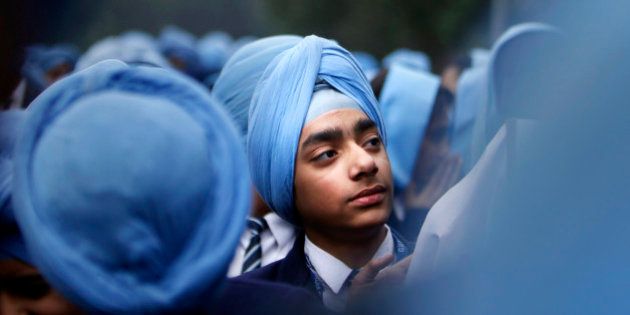 Indian Sikh school students participate in a protest against the ban on wearing turban in public schools in France, in New Delhi, India, Friday, Feb. 15, 2013 on the occasion of a two-day visit of French President Francois Hollande in India. (AP Photo/Tsering Topgyal)