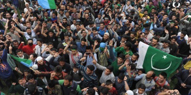 Kashmiri muslims shout anti-India and pro-freedom slogans as Kashmiri separatist leader Syed Ali Shah Geelani addresses a rally on his return from New Delhi, in Srinagar on April 15, 2015. Thousands attended the rally in the summer capital of the restive state of Jammu and Kashmir, designed as a show of strength for Geelani. AFP PHOTO / Tauseef MUSTAFA (Photo credit should read TAUSEEF MUSTAFA/AFP/Getty Images)