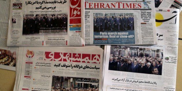 A picture taken in Tehran on January 12, 2015 shows the front pages of Iranian newspapers displaying headlines in response to the recent Islamist attacks that killed 17 people, most at the Paris offices of satirical magazine Charlie Hebdo. More than a million people flooded Paris on Sunday in an unprecedented rally against terrorism, led by dozens of world leaders walking arm in arm as cries of 'Freedom' and 'Charlie' rang out. AFP PHOTO / ATTA KENARE (Photo credit should read ATTA KENARE/AFP/Getty Images)