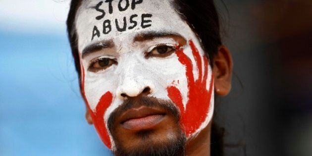 An Indian protester with a slogan painted on his face participates in a demonstration to protest against police inaction after a six-year-old was allegedly raped in a school, in Bangalore, India, Sunday, July 20, 2014. More than a hundred protesters gathered Sunday and demanded that police arrest those involved in the July 2 incident, which was reported only this past week. The rape has raised questions about the safety of India's schoolchildren and sparked nationwide outrage over rampant sexual violence against girls and women. (AP Photo/Aijaz Rahi)