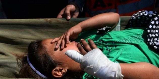 An injured Nepalese child is stretchered from an Indian Army helicopter at Pokhara Airport on May 5, 2015, after being rescued from the mountains of Gorkha following a 7.8 magnitude earthquake which struck the Himalayan nation on April 25. Nepalese authorities said that a vast army of emergency workers was finally managing to deliver aid to stranded survivors of a massive earthquake as the death toll from the disaster rose to 7,557. AFP PHOTO/SAJJAD HUSSAIN (Photo credit should read SAJJAD HUSSAIN/AFP/Getty Images)