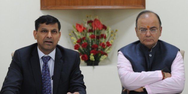 Indian finance minister Arun Jaitely (R) along with Reserve Bank of India (RBI) governor Raghuram Rajan (L) addresses a press conference after a meeting with the Central Board of Directors of the Reserve Bank of India in New Delhi on August 10, 2014.India's central bank governor Raghuram Rajan has defended his recent decision to keep the interest rates unchanged, reassuring that the current policy will bring down the spiralling inflation. Rajan addressed a meeting of the central board of the Reserve Bank of India (RBI) in New Delhi, which met with the finance minister Arun Jaitley for the first time after he presented the maiden budget of his right-wing government in July. AFP PHOTO/ SAJJAD HUSSAIN (Photo credit should read SAJJAD HUSSAIN/AFP/Getty Images)