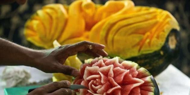 An Indian chef craves a watermelon during a fruit and vegetable carving compitition at the 28th AAHAR...