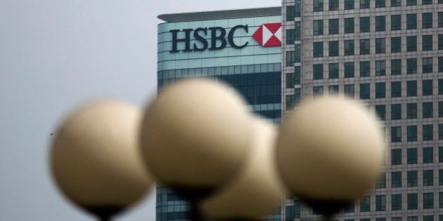 Street lamps stand in the foreground as an exterior views shows a logo on the global headquarters building of HSBC in the Canary Wharf business district of London, Friday, April 24, 2015. HSBC is considering moving its headquarters from Britain in the wake of