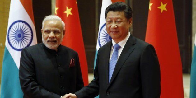 India's Prime Minister Narendra Modi (L) and China's President Xi Jinping shake hands before they hold a meeting in Xian, in China's Shaanxi province, on May 14, 2015. Modi began a three-day trip to China on May 14 by inspecting the Terracotta Warriors as a festering border dispute colours relations between the Asian giants. AFP PHOTO / POOL / Kim Kyung-Hoon (Photo credit should read KIM KYUNG-HOON/AFP/Getty Images)