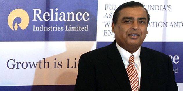 Reliance Industries Chairman Mukesh Ambani poses as he arrives for the company's annual general meeting in Mumbai on June 6, 2013. India's largest private firm Reliance Industries plans to invest 1.5 trillion rupees (USD26 billion) in all its businesses over the next three years, its chairman Mukesh Ambani told shareholders. Reliance is India's largest private oil and gas explorer with a strong presence in the petrochemicals and polyester sectors and has expanded into the fast-growing broadband and retail segments in recent years. AFP PHOTO/Indranil MUKHERJEE (Photo credit should read INDRANIL MUKHERJEE/AFP/Getty Images)