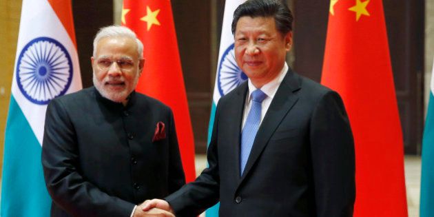 Indian Prime Minister Narendra Modi, left, and Chinese President Xi Jinping pose for a photo prior to their meeting in Xian, Shaanxi province, China, Thursday, May 14, 2015. Modi is visiting China this week to build friendship between the two Asian giants despite a long history of disputes and rivalries, along with some areas of cooperation, especially in the economic sphere. (Kim Kyung-Hoon/Pool Photo via AP)