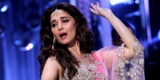 Indian Bollywood film actress Madhuri Dixit, as a judge, performs during the grand finale of the television dance reality show 'Jhalak Dikhhla Jaa Season 7' in Mumbai on September 18, 2014. AFP PHOTO (Photo credit should read STR/AFP/Getty Images)