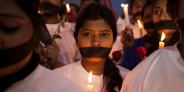 Indian women participate in a candle light vigil at a bus stop where the victim of a deadly gang rape in a moving bus had boarded the bus two years ago, in New Delhi, India, Tuesday, Dec. 16, 2014. The case sparked public outrage and helped make womenâs safety a common topic of conversation in a country where rape is often viewed as a womanâs personal shame to bear. (AP Photo/Tsering Topgyal)